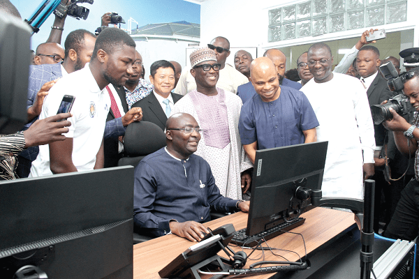 Vice-President Dr Mahamudu Bawumia (seated) testing the new electronic cargo tracking system. Behind him are some invited guests. Picture: BENEDICT OBUOBI
