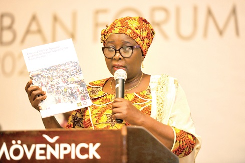 Hajia Alima Mahama, showing a copy of the guidelines for Ghana's national urban policy revision to participants 