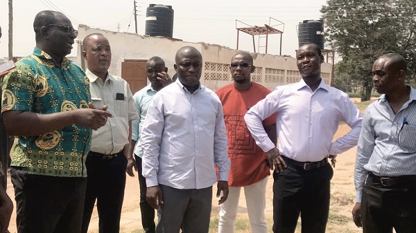 Mr Ebo Sey (left), the Assistant Headmaster of the school, explaining a point to Mr Mohammed Adjei Sowah (middle) during a visit to the school.