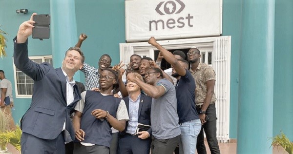  Mr Casper Klynge (left) in a pose with some IT staff of Ministry of Enviornment Science and Techonology during his visit to Ghana
