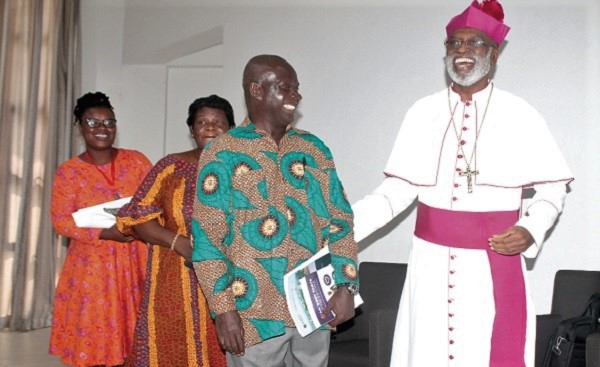 Archbishop Gabriel Charles Palmer-Buckle (right) interacting with Prof. Kofi Agyekum (2nd right), after a panel discussion at the New Year School and Conference, at the University of Ghana. With them is Ms Rebecca Tandoh (left), Information and Communication Specialist, UNESCO.