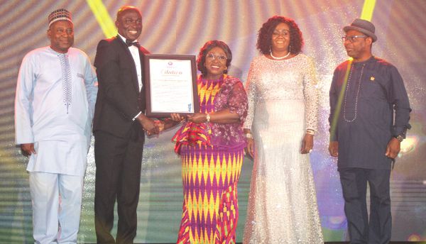 Dr Edward Ackah Nyamike (2nd left), President of the Ghana Hotels Association presenting a citation to Mrs Akosua Frema Osei-Opare (3rd right), Chief of Staff, who received it on behalf the President Nana Addo Dankwa Akufo  Addo at the Ghana Hotels Association awards in Accra. Picture GABRIEL AHIABOR