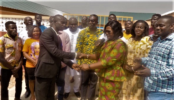 Ms Victoria Adu handing over the keys to the building to Mr Benjamin Cudjoe. 