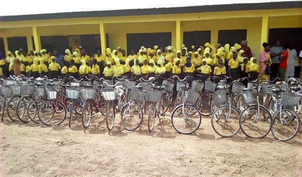 Students and staff of Kpalga Ponaa Girls Junior High School standing in front of the new building and the donated bicycles by the assembly