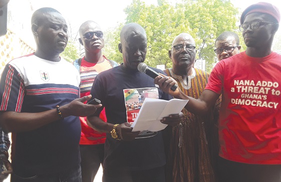 The Leader of the Group, Mr Donatus Akamugri reading the petition when the members picketed at the Upper East Regional Office of the EC in Bolgatanga