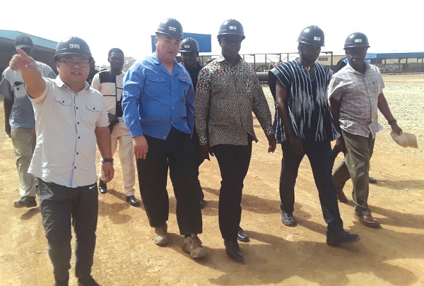 Mr Kwaku Asomah-Cheremeh (3rd right) and his team being conducted round the mining site of Shaanxi Mining Company.