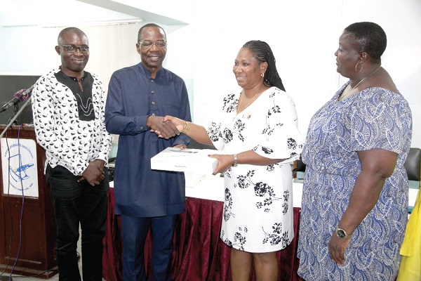 Mr Affail Monney (2nd left), GJA President, presenting the 2018 Journalist of the Year prize to Ms Doreen Hammond (2nd right). With them are Ms Mary Mensah (right), Public Relations Officer, GJA, and Mr Kofi Yeboah (left), General Secretary, GJA.