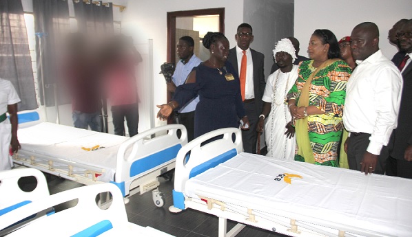 Ms Margaret Akuamoah (left) of the Ussher Polyclinic explaining a point to Mrs Rebecca Akufo-Addo (2nd right), Mohammed Adjei Sowah (right), Metropolitan Chief Executive of Accra, Mr Niyi Ojuolape (2nd left), UNFPA Country Representative and other dignitaries.