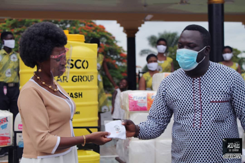 Mr Ebenezer Mantey Oduro(right) handing over an item to Ms Golda Esi Andam(left), the headmistress of SWESCO during the ceremony.