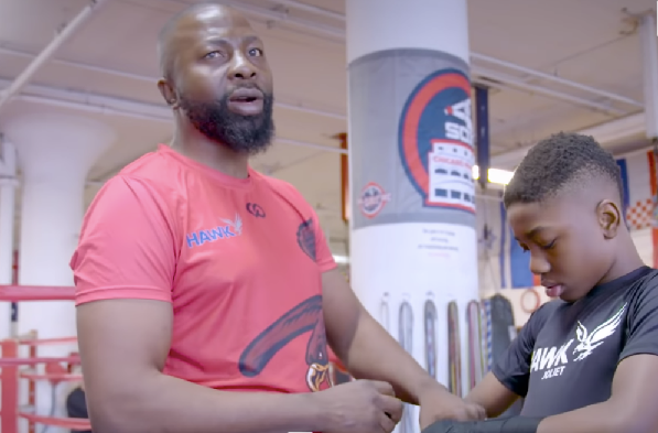 Joseph Awinongya Jnr (left) getting his son ready for a bout