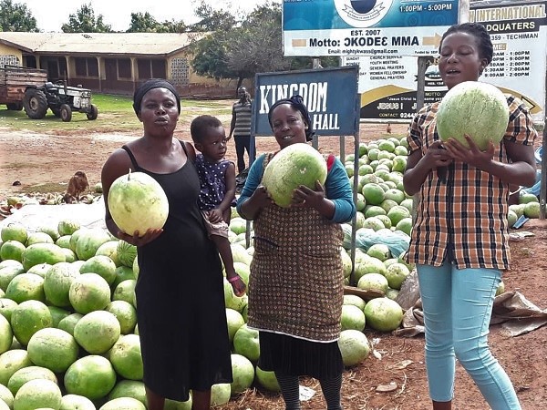Ms Joyce Anima (middle), Ms Cynthia Sarcomas and another watermelon seller displaying the fruit which has become their main source of livelihood