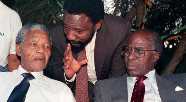 Nelson Mandela, left, and Andrew Mlangeni, right, listen to Cyril Ramaphosa in 1993