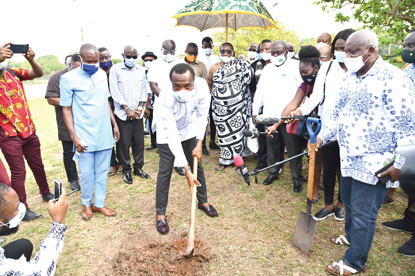 Mr Jerry Ahmed Shaib, CEO of the Coastal Development Authority, digging the ground to signify the commencement of work. Looking on are some of the dignitaries at  the ceremony Picture: EBOW HANSON