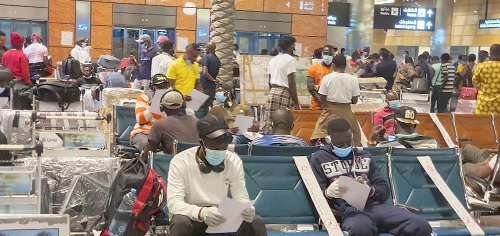 Some of the evacuees going through departure protocols at the Hamad International Airport in Doha