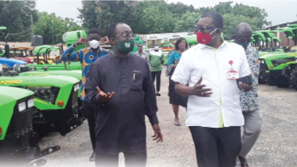 Dr Akoto conducting Mr Kobby Asmah (right), Editor of the Daily Graphic, round the tractors