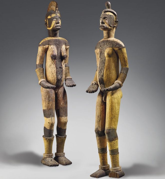 The wooden objects, one male and one female, represent deities from the Igbo community