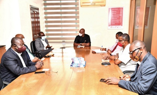 Mr Kurt Okraku (3rd left) speaking at the meeting with Mr Ato Afful (middle), the Managing Director of the Graphic Communications Group Limited, while other officials of the GFA and the GCGL listen attentively