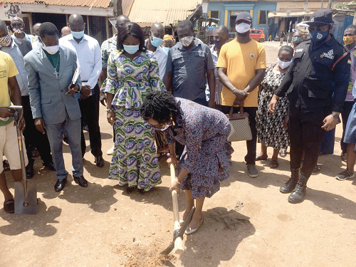 Mrs Cynthia Morrison, MP for Agona West and Minister for Gender, Children and Social Protection, cutting the sod for the projects to begin, while Mrs Justina Marigold Assan (2nd left), MCE for Agona West, and guests look on