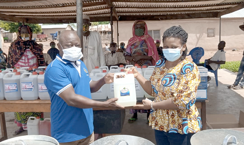  Ms Gloria W. Akugri presenting the items to Mr Abdul-Hanan Dason Anas