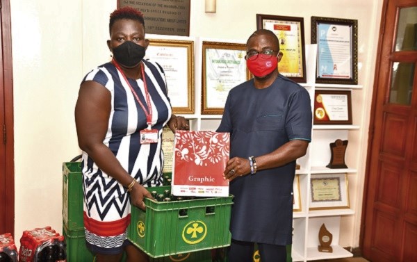 Mr Charles Benoni Okine (right) receiving a prize from Mrs Hadiza Quansah, Assistant Editor, The Mirror, for being the Overall Best and the Best Male­­­ dressed, during the competition. 