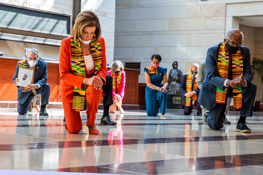 House Speaker Nancy Pelosi (D-Calif.) and other members of Congress observe a moment of silence at the Capitol's Emancipation Hall on Monday. (Manuel Balce Ceneta/AP)