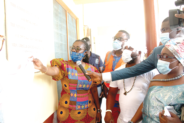 Mrs Ursula Owusu Ekuful (left) unveiling a plaque to inaugurate the Manhean community ICT centre. Behind her is Mr Clement Nii Lamptey Wilkinson, Municipal Chief  Executive, Ablekuma West and Manye Naa Sakwa I (right), Queenmother of Manhean.