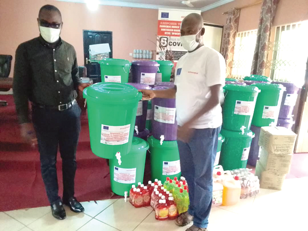  Mr Rashid (right), Executive Director of Urbanet, presenting the items to Mr Abukari (left), Coordinating Director of the Central Gonja District Assembly