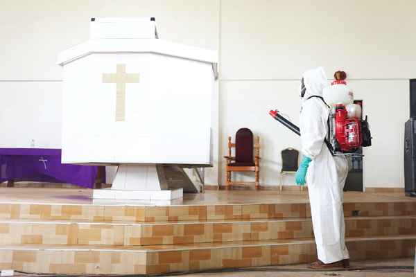 A Zoomlion worker disinfecting the church auditorium