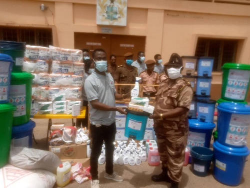 Mr Jonathan Osei Owusu, the Executive Director, POS Foundation (left) presenting the covid-19 items to Chief Superintendent Francis Yao Adzaklo, Deputy Commander, Navrongo Central Prisons