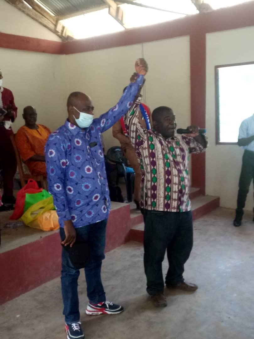 The District Electoral Officer, Eric Gyamfi-Boateng (rght) raising A.C. Ntim's hand as the elected parliamentary candidate for the NPP in Offinso North
