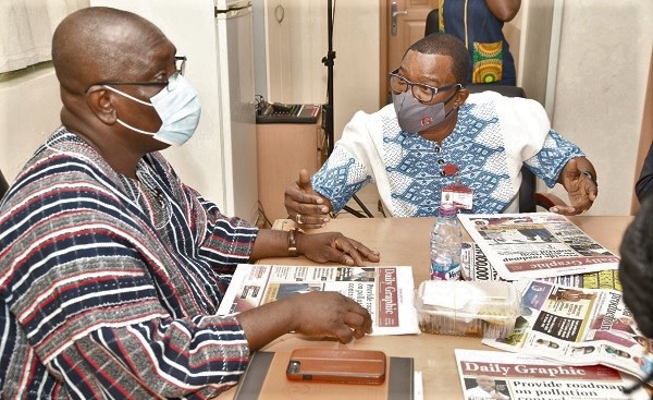  Mr Kobby Asmah (right), Editor of the Daily Graphic, giving some titbits on selection of stories to Dr Yaw Baah when he took over as Guest Editor of the Daily Graphic. Picture: EBOW HANSON  