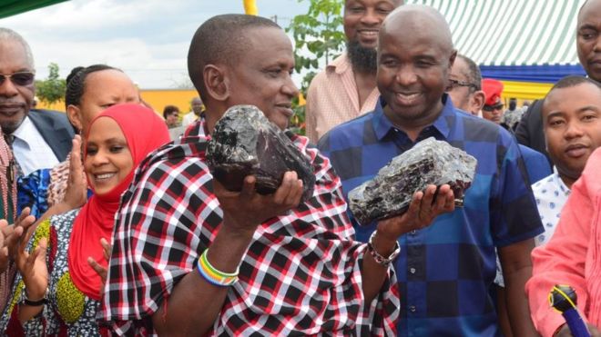 Mr Laizer - holding up the precious stones - plans to build a school and a shopping centre in his community