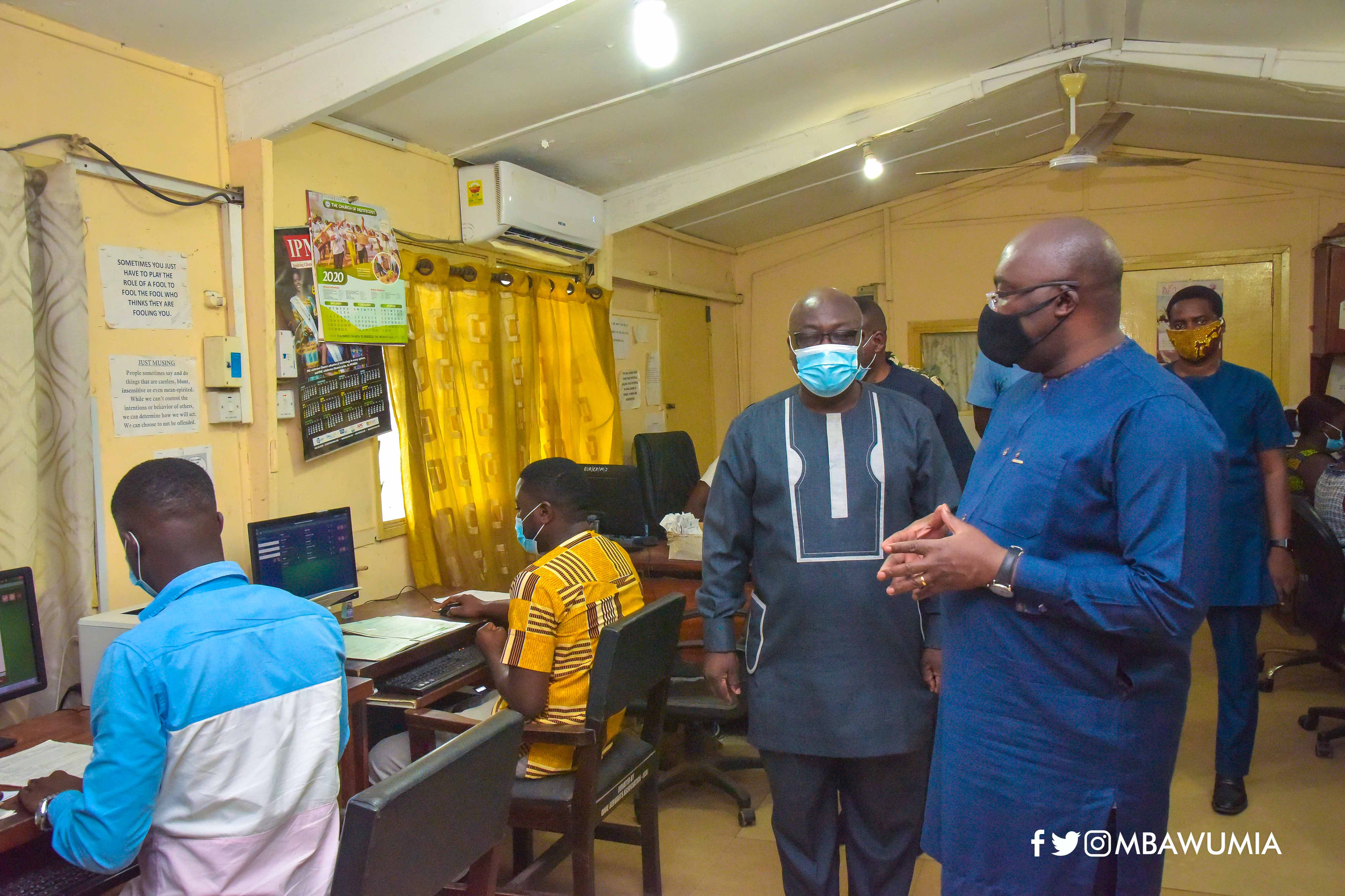 Dr Mahamudu  Bawumia (right) being conducted round at the head office of the Births and Deaths Registry in Accra by Rev. Asare Addo