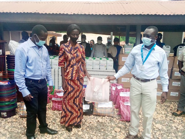 Mr Amoah (right) presents one of the items to the Headmistress of Bontefufuo SHS while her colleague from Manso Adubia SHS look on.