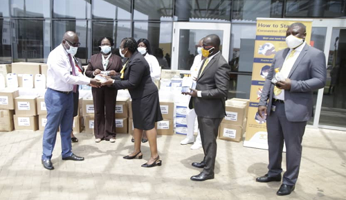 Dr Darius Osei (extreme left), CEO, Legon Medical Centre receiving the item from Mrs Barbara Hanson, Chief Risk Officer, CalBank. With them is Mr Samuel K. Boafo (2nx right), Head, Human Resource, CalBank inspecting the items.  Picture by  Samuel Tei Adano