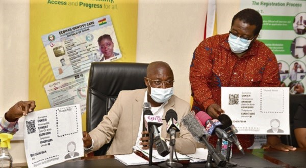  Prof. Ken Agyeman Attafuah (seated) displaying a dummy Ghana Card at the press conference. With him is Mr Francis Palmdeti, Head, Corporate Affairs, NIA.  Picture: EBOW HANSON