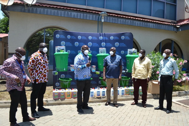 Mr Thomas Alonsi (left), DG of the GMA and Mr Kwame Kumah, National Chairman of GPRTU, performing the symbolic COVID-19 greeting to signify the presentation.