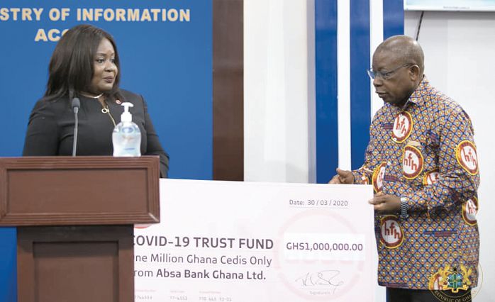  Nana Essilfuah Boison presenting the dummy cheque to Mr Kwaku Agyeman-Manu