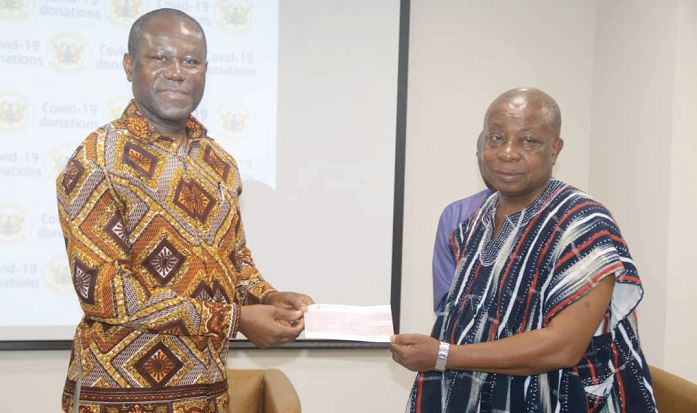 Mr Joseph Boahen Aidoo (left) presenting a cheque for GH¢200,000 to Mr Kwaku Agyeman-Manu in support of fight against the COVID-19 pandemic in the country.