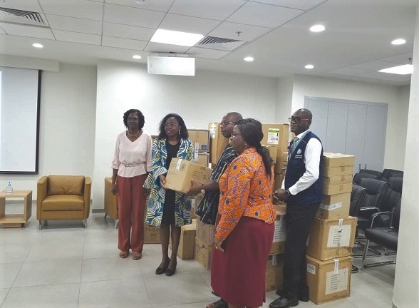 Dr Neema Rusibamayila Kimambo (2nd right), the WHO Country Representative, presenting the PPE to Mr Alexander Abban