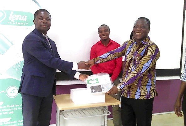Mr Richard K. Odor (left), the CEO of Lena Health Services, presenting the ECG machine to Dr Lord Mensah (right), the Assistant Director of Medical Affairs at the Ho Teaching Hospital