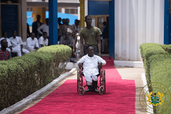Prince Yeboah, wheeling his friend Marvin Okyere Jnr to pick his award donated by a benefactor in the US