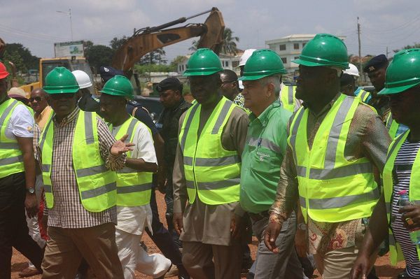  Mr Alex Bruks (hand raised) explaining a point to the Asantehene, Otumfuo Osei Tutu II, during the tour of the nearly completed Garden City Mall in Kumasi Those with them include Nana Atta Poku (right) and Mr Stefano Ramella (2nd right), Managing Director, Consar Construction Limited