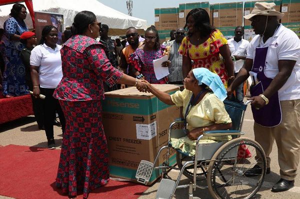Mrs Akufo-Addo presenting a deep freezer to one of the beneficiaries