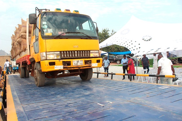 A cargo vehicle loaded with bags of cashew nuts being weighed