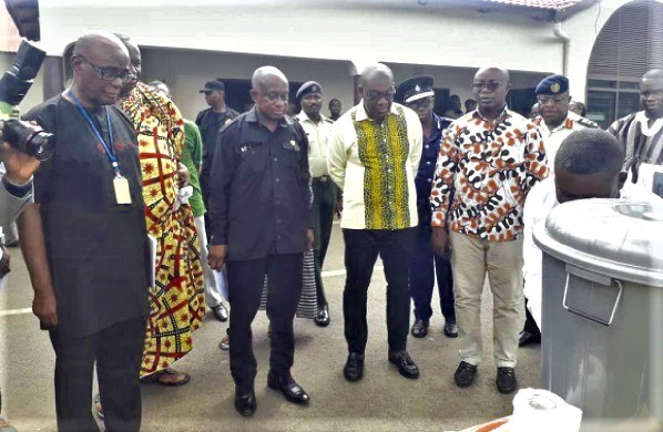 Mr Kojo Oppong Nkrumah (3rd right) with Mr Simon Osei Mensah (3rd left), the Ashanti Regional Minister, and Mr Osei Assibey Antwi (2nd right), Kumasi Metropolitan Chief Executive, being shown the handwashing area set up at the palace