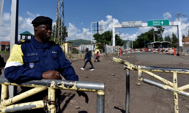 A police officer guards the deserted border crossing between the Democratic Republic of the Congo and Rwanda. Photograph: Olivia Acland/Reuters