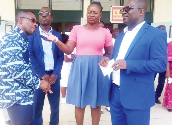 Mr Kwamena Duncan (left), the Central Regional Minister, after handing over the cheque to Dr Ngyedu 