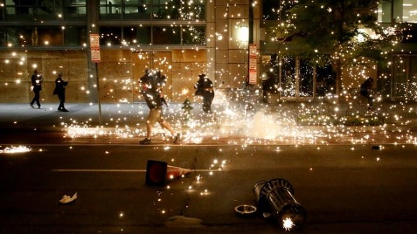 Protesters run as police use flash grenades to disperse crowds in Washington, DC