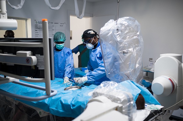 Doctors performing intra arterial chemotheraphy to cure the child of eye cancer